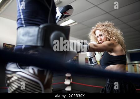 Adult Woman in boxing gloves fighting with partner Stock Photo