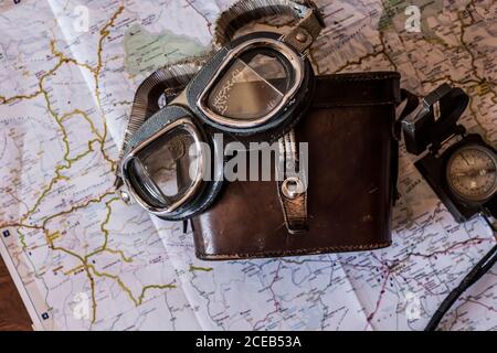 planning a trip on a map with vintage motorcycle glasses and old prismatic Stock Photo