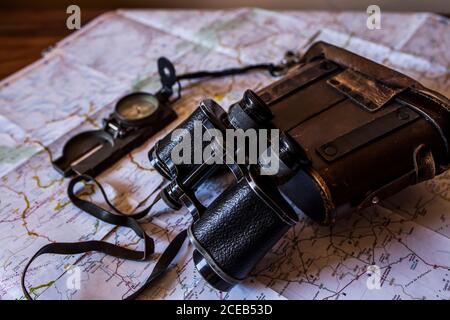 planning a trip on a map with prismatic and compass Stock Photo