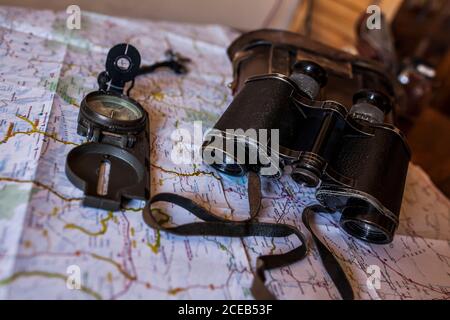 planning a trip on a map with prismatic and compass Stock Photo