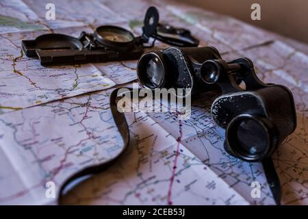 planning a trip on a map with prismatic and compass Stock Photo