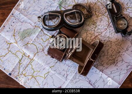 planning a trip on a map with vintage motorcycle glasses, old photo camera Stock Photo