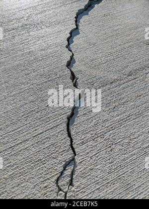 Long crack in slab of brushed concrete Stock Photo