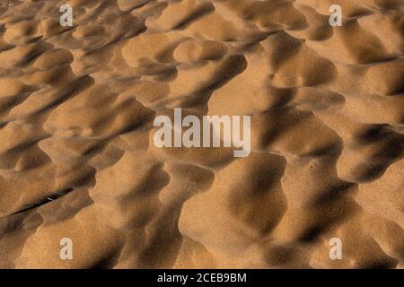 The desert floor reflects a history of seasonal rains and wind moving the sand, creating beautiful abstract patterns Stock Photo