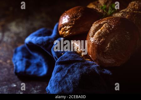 freshly baked buns with almonds.Croissants an brioche.On dark background Stock Photo