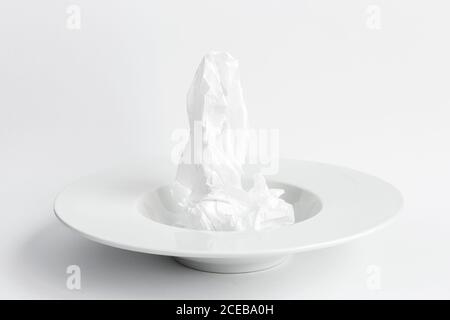 Wrinkled paper on plate Stock Photo