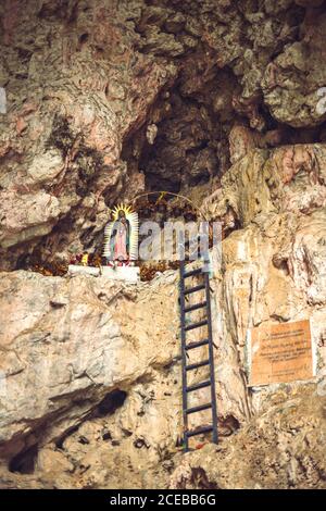 Small ladder leading to shrine dedicated to Lady of Guadalupe and located on rocky cliff of Sumidero Canyon in Chiapas, Mexico Stock Photo