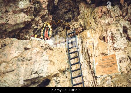 Small ladder leading to shrine dedicated to Lady of Guadalupe and located on rocky cliff of Sumidero Canyon in Chiapas, Mexico Stock Photo