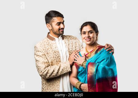 Indian asian old Mother and adult son in traditional wear, standing isolated over white background Stock Photo