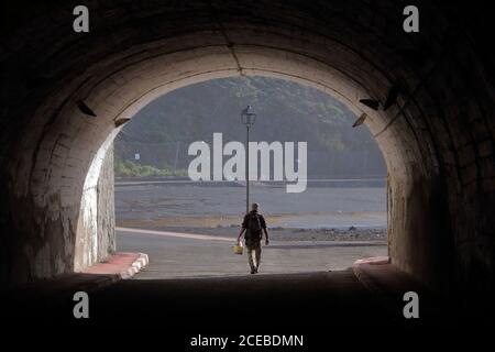 Silhouette of a man in a tunnel Stock Photo