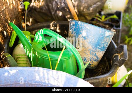From above shot of various gardening tools lying in plastic bucket on sunny day on farm Stock Photo