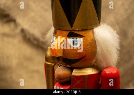 Nutcracker wooden figure of a soldier for cracking nuts. Traditional symbol of Christmas and New Year. Close up Stock Photo