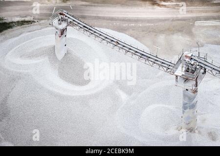 Drone view of two towers with conveyor belts transporting cement on factory in Asturias, Spain Stock Photo
