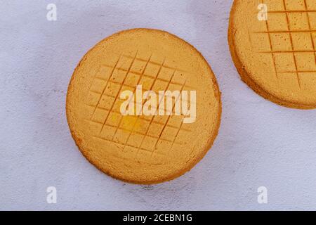 Textured sponge cake on white surface. Top view. Stock Photo