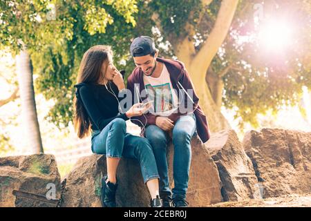 Couple with smartphone in park Stock Photo
