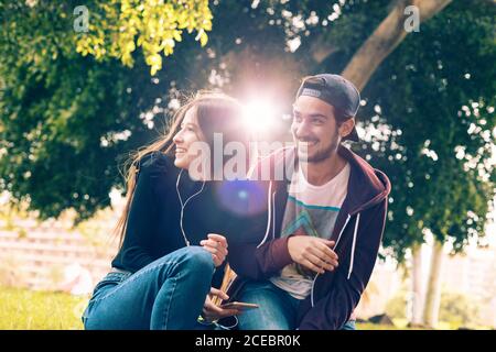 Couple with smartphone in park Stock Photo