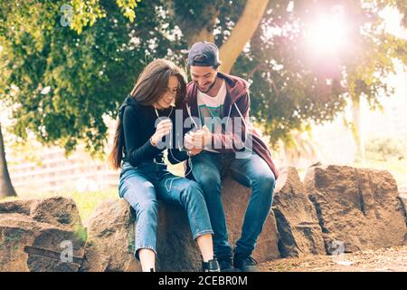 Couple with smartphone in park Stock Photo