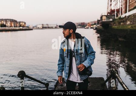 Cheerful man with camera on embankment Stock Photo