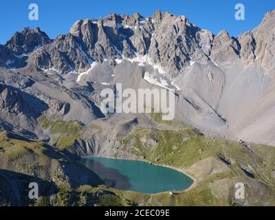 AERIAL VIEW. Lac Sainte-Anne, a tarn (alt: 2414m) at the foot of  pics de la Font Sancte (alt: 3385m). Ceillac, Hautes-Alpes, France. Stock Photo