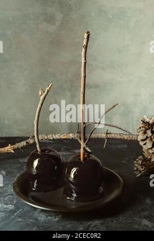 Black caramel apples, ready to eat at the fall snack on Halloween Stock Photo