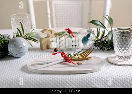 Holiday celebration table setting, marble dish and golden cutlery. white and gold colors Stock Photo
