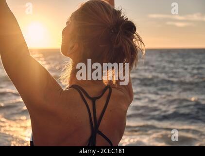 Young Woman doing yoga during sundown Stock Photo