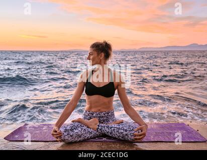 Woman meditating near sea Stock Photo