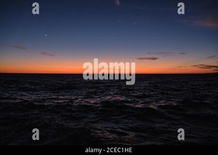 Dark sunset sky over sea Stock Photo