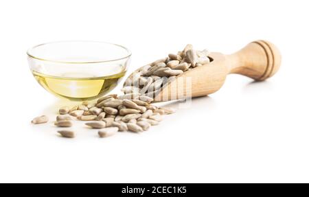 Peeled sunflower seeds and oil isolated on white background. Stock Photo
