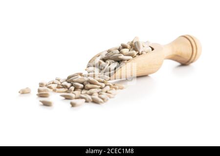 Peeled sunflower seeds in wooden scoop isolated on white background. Stock Photo