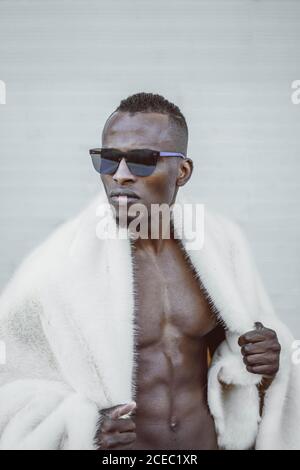 Stylish black man in fur coat Stock Photo