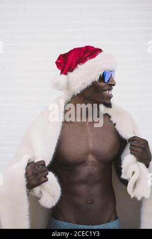 Excited black man in Santa Claus costume Stock Photo