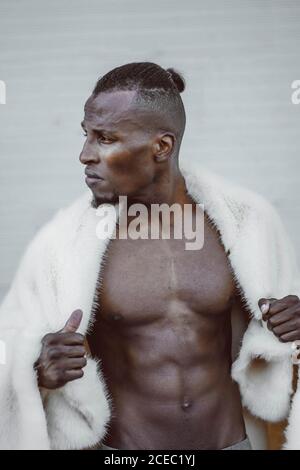Stylish black man in fur coat Stock Photo