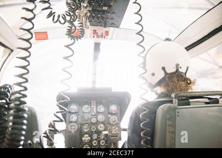 Woman pilot sitting in the helicopter Stock Photo