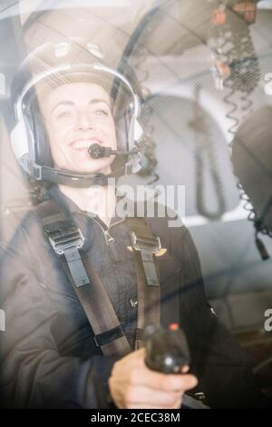Attractive Woman pilot sitting in the helicopter Stock Photo