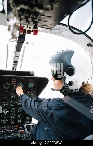 Attractive Woman pilot sitting in the helicopter Stock Photo