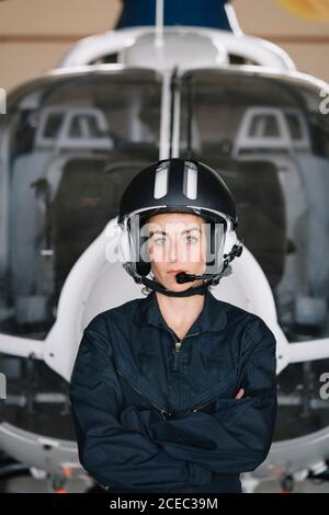 Portrait attractive Woman helicopter pilot In the hangar Stock Photo