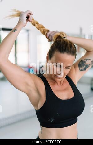 Beautiful woman adjusting her bra Stock Photo - Alamy