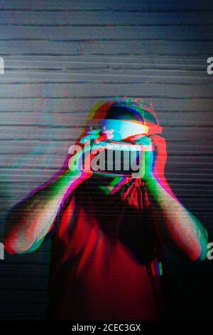 man testing VR glasses in the night Stock Photo