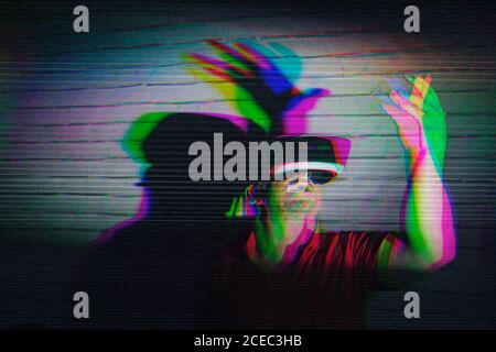 man testing VR glasses in the night Stock Photo