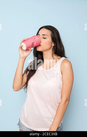 Young Woman with pink glass Stock Photo