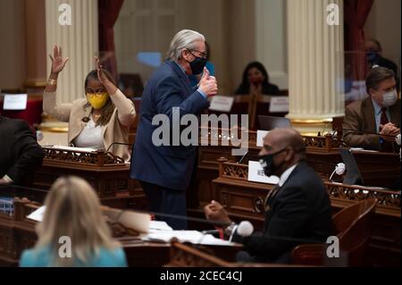 Sacramento, CA, USA. 31st Aug, 2020. Bill Monning, D-Carmel reacts after passage of SB 1102 with Mitchell, D-Los Angeles In the Senate chambers at the State Capital on Monday, Aug 31, 2020 in Sacramento. Tensions in the California Senate boiled over Monday evening as Democrats limited debate on bills and Republicans complained of technical glitches interfering with their ability to vote as the clock ticked toward a midnight deadline for lawmakers to act on policy for the year. Credit: Paul Kitagaki Jr./ZUMA Wire/Alamy Live News Stock Photo