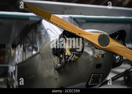 Close-up shot of airscrew on nose cone of small plane standing in hangar Stock Photo