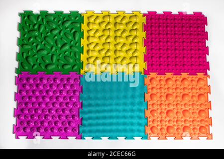 Orthopedic mats view from above. Bright colorful multicolored mats to prevent flat feet and foot massage. Stock Photo