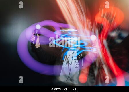 Woman playing VR game with controller Stock Photo