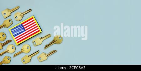 American flag and keys on a gray background. VA mortgage or Department of Veterans Affairs home loan. Stock Photo