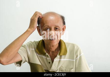Asian men scratching their heads bald older senior men portrait. Stock Photo