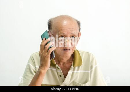 older senior men portrait.Bald Asian man wearing glasses talking on the phone Stock Photo