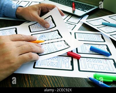 Ux ui designer working with web mobile app sketches. Stock Photo