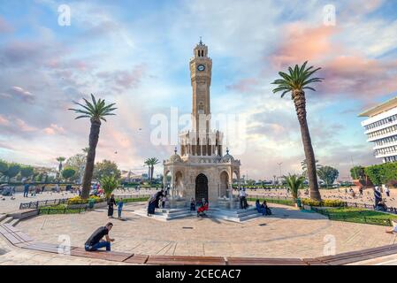Konak Square street view with old clock tower (Saat Kulesi) at sunset. It was built in 1901 and accepted as the official symbol of Izmir City, Turkey Stock Photo